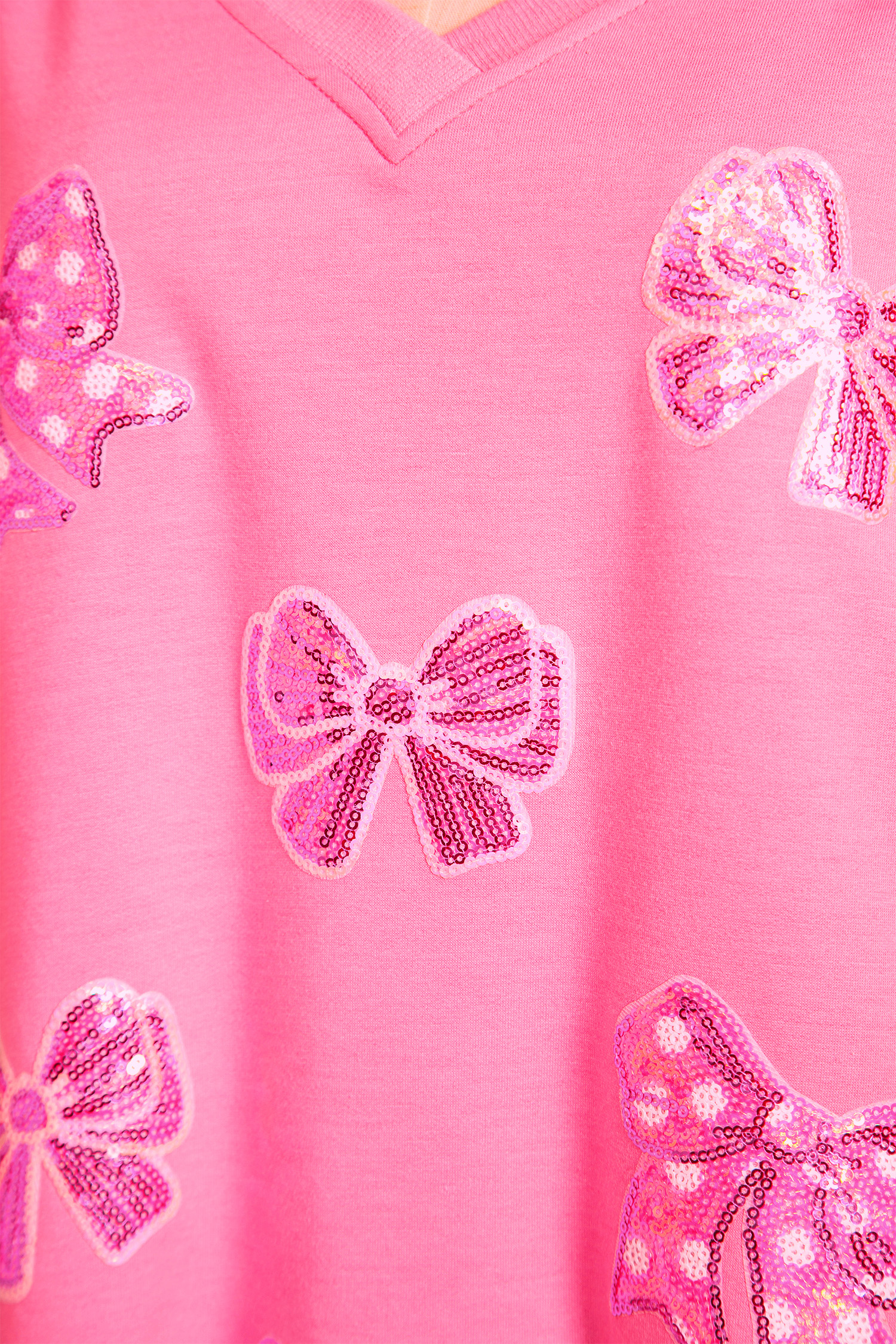 Bonbon Sequined Bow Patched Exposed Seam Bracelet Sleeve High Low T Shirt