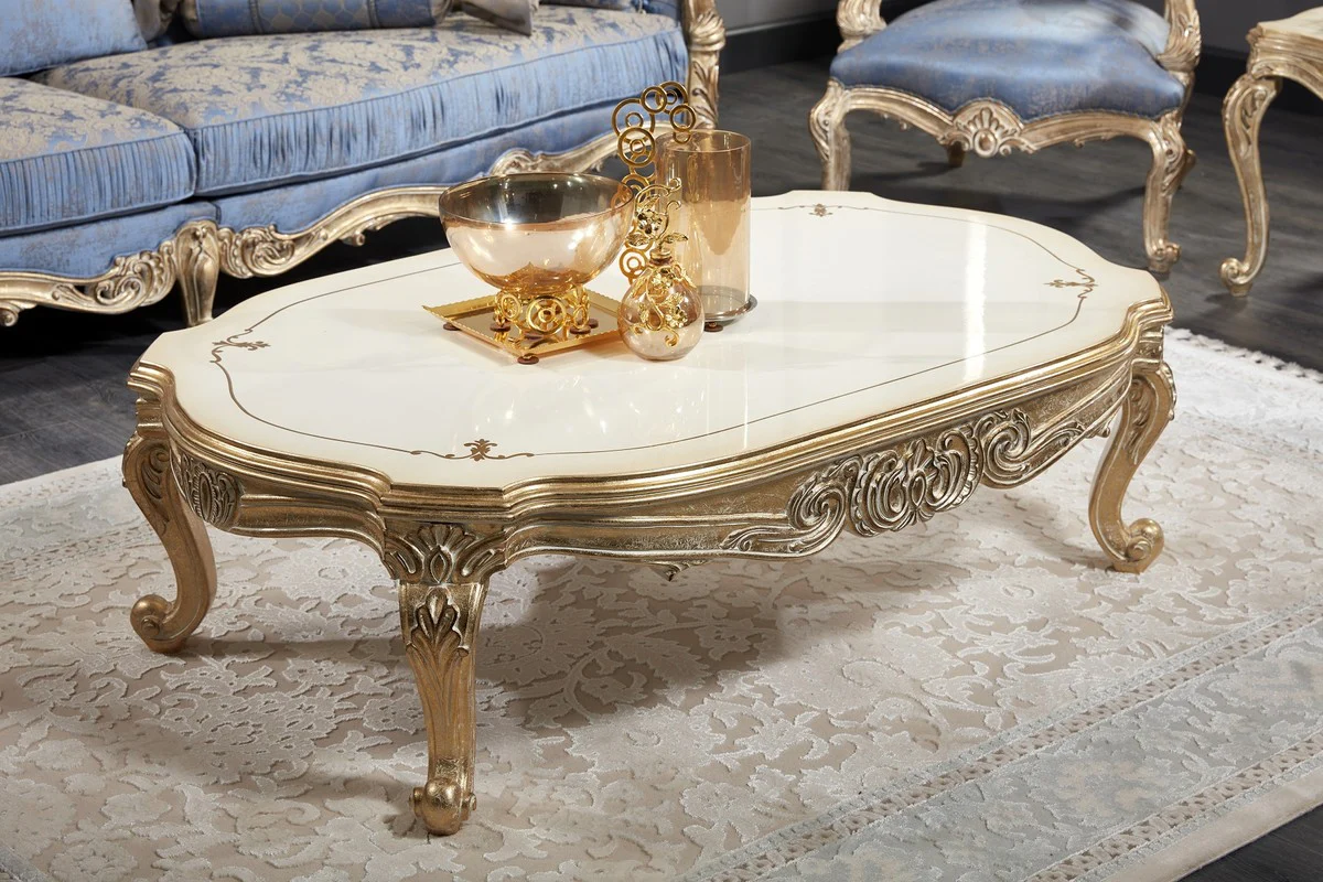 Luxus Barock Couchtisch Weiß / Antik Gold 143 x 94 x H. 44 cm - Prunkvoller Barock Wohnzimmertisch