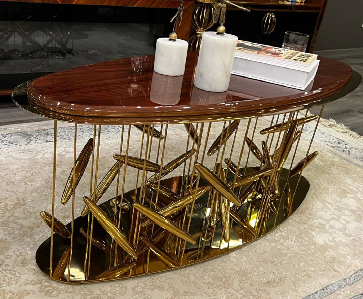 Luxus Couchtisch Braun / Gold 120 x 51 x H. 47 cm - Ovaler Edelstahl Wohnzimmertisch mit Massivholz Tischplatte - Wohnzimmer Möbel - Hotel Möbel - Luxus Möbel